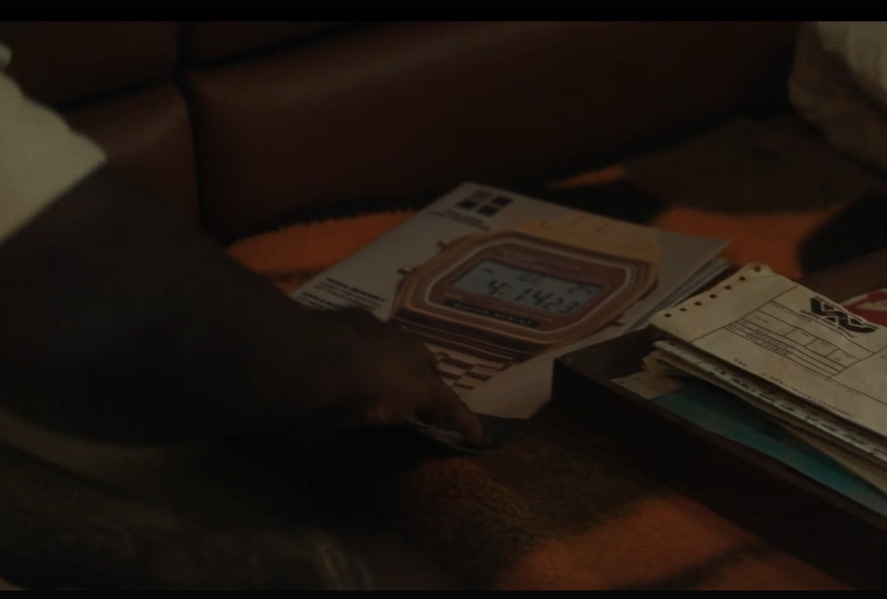 captura de la serie Alien Earth, con una revista (o catálogo) donde sale un reloj digital de color oro tanto la caja como la correa